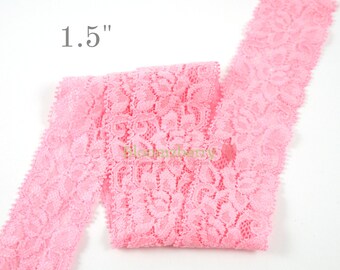 May include: Pink lace trim with a delicate floral pattern, measuring 1.5 inches wide.