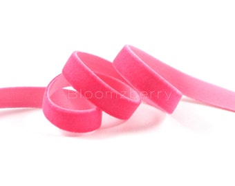 May include: A pink velvet ribbon, coiled and ready for crafting projects.