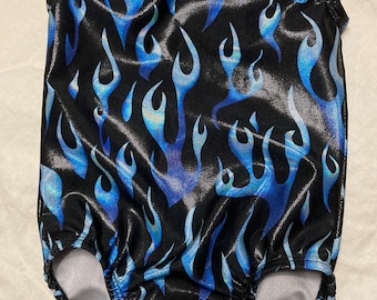May include: A black leotard with a blue and silver flame pattern. The leotard has a scoop neck and a racerback style.