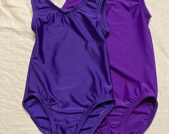 May include: Two purple leotards with sleeveless straps and a scoop neck.