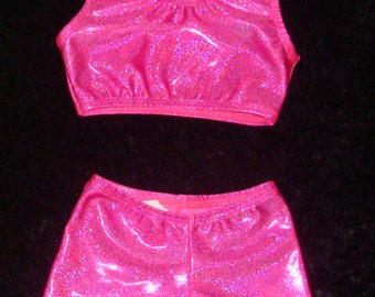 May include: A pink sparkly crop top and matching shorts. The fabric has a glittery finish.