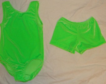 May include: A bright green leotard and matching shorts made of velvet. The leotard has a scoop neck and sleeveless design. The shorts have a wide waistband.