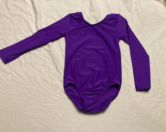 May include: A purple long-sleeved leotard with a scoop neck.