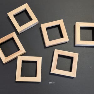 May include: Five square, light-colored wooden frames arranged in a scattered pattern. Each frame features a simple, flat-faced design with mitered corners and a hollow center. The text 1026 9 is printed in small white font at the bottom center.
