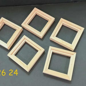 May include: Five square wooden frames with a light natural finish and mitered corners. The frames are arranged in a scattered pattern. The yellow text 726 24 is visible in the lower left corner of the image, indicating a product reference.