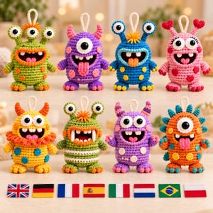 May include: Eight colorful crocheted monster ornaments with various eye counts, horns, and patterns. Each creature features a small hanging loop on top. Below the monsters are eight small rectangular flags representing different nations.