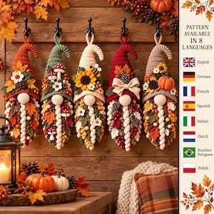May include: Five hanging crochet gnome ornaments featuring autumn-themed decorations including fabric leaves, flowers, pinecones, mushrooms, sunflowers, a bee, and a small pumpkin. Each gnome has a pointed hat and a textured, braided white beard.