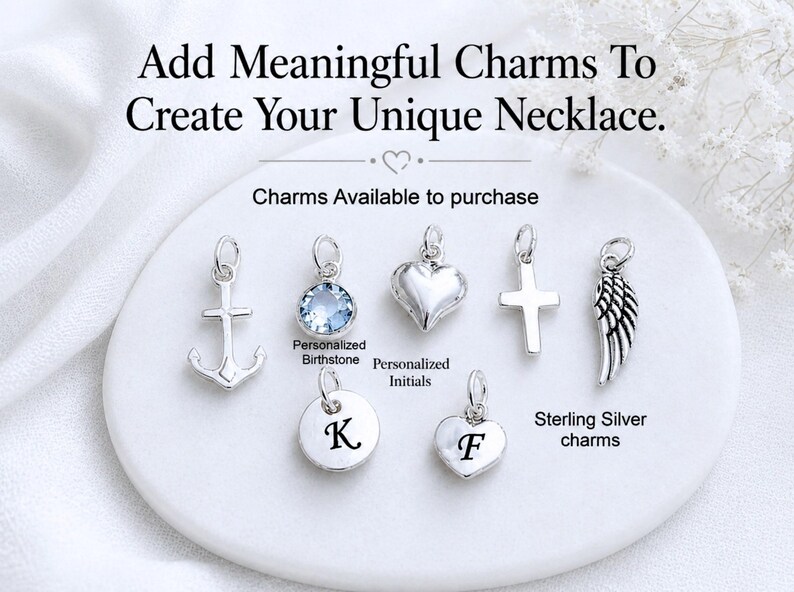 May include: A collection of silver-toned charms including an anchor, a light blue crystal, a heart, a cross, a wing, and two circular and heart-shaped discs engraved with the letters K and F. Text reads: Add Meaningful Charms To Create Your Unique Necklace.
