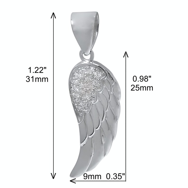 May include: Silver angel wing pendant with clear cubic zirconia stones. The wing measures 1.22 inches tall, 0.98 inches wide, and 0.35 inches thick.