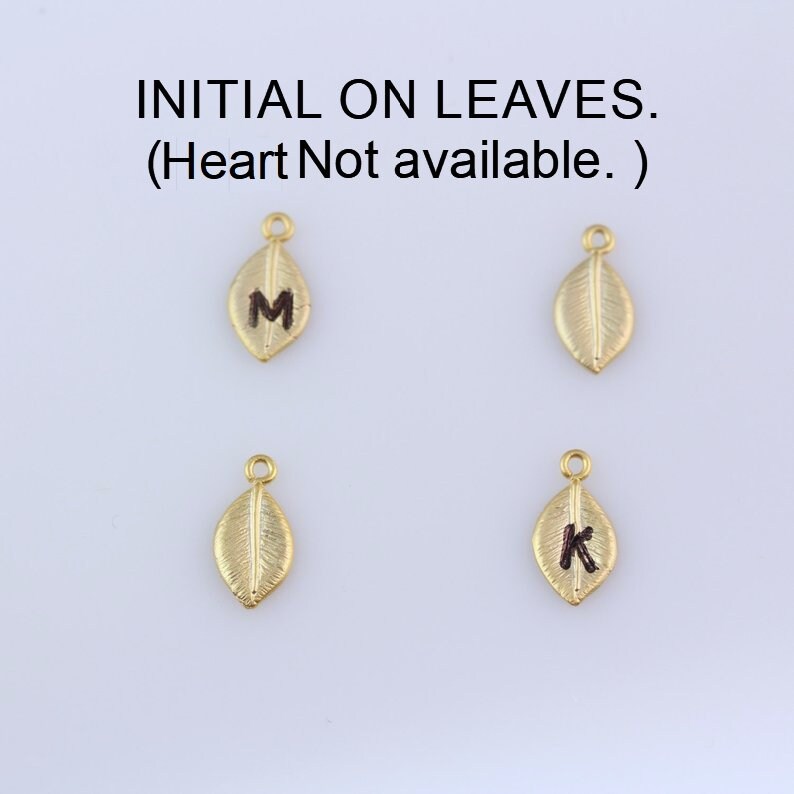 May include: Four gold leaf charms with initial letters M and K.  INITIAL ON LEAVES. (Heart Not available.)