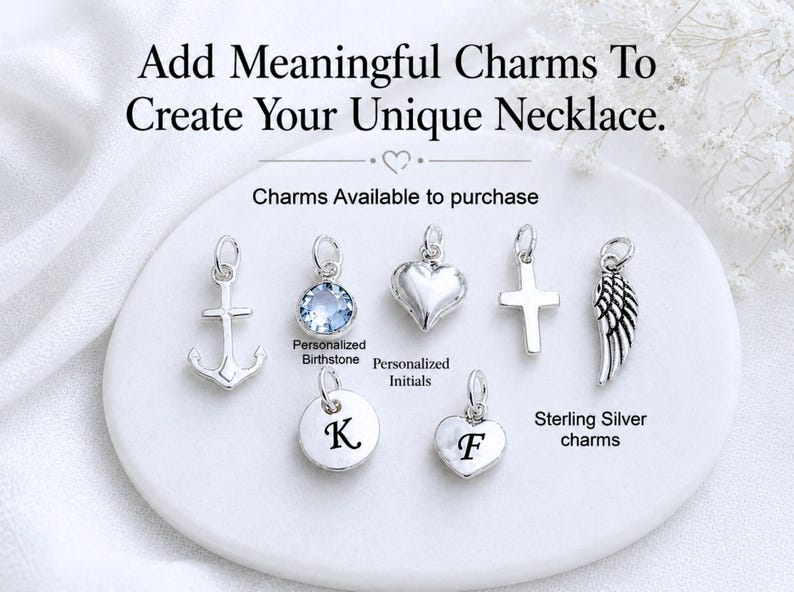 May include: A collection of seven sterling silver charms including an anchor, a light blue birthstone, a heart, a cross, a wing, and two round and heart-shaped discs engraved with the initials K and F. Text reads: Add Meaningful Charms To Create Your Unique Necklace.