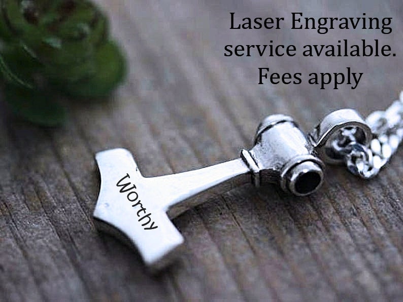 May include: A silver-toned metal pendant shaped like a hammer, featuring the word Worthy engraved on its side. The pendant is attached to a silver-toned chain. Text in the image reads: Laser Engraving service available. Fees apply.
