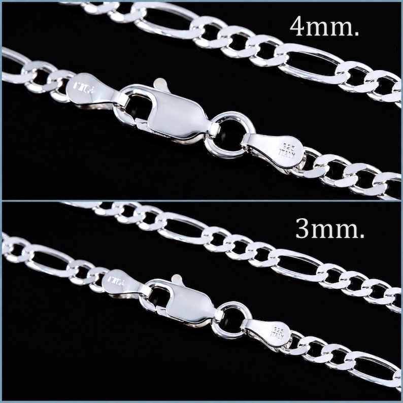 May include: Two silver Figaro chains featuring a lobster claw clasp and stamped 925 Italy markings. The top chain is 4mm wide, and the bottom chain is 3mm wide. Both chains consist of alternating oval and circular links with a polished finish.
