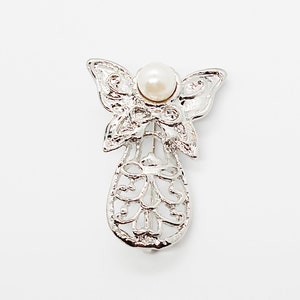 Vintage angel brooch pin with swirly pattern & butterfly wings : silver tone metal with white faux pearl ; about 1 1/2 x 1 in.