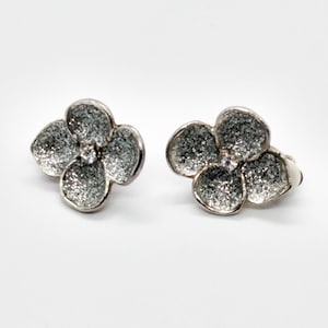 Vintage sparkly silver tone flower clip-on earrings with rhinestones and glittery petals