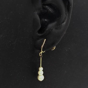 Vintage gold tone dangle screw back earrings with three white faux pearls ; about 1 1/2 in. long