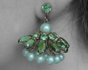 May include: A pair of dangle earrings with a green stone at the top and a cluster of smaller green stones and pearls hanging below.