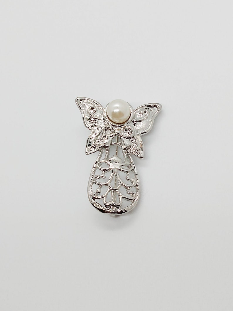 Vintage angel brooch pin with swirly pattern /& butterfly wings silver tone metal with white faux pearl ; about 1 12 x 1 in.