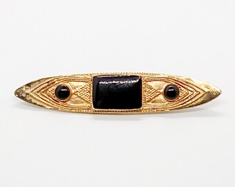 Vintage black & gold tone marquise brooch pin : gold tone metal and hardware with decorative line art and black stones ; about 3 x 1/2 in.