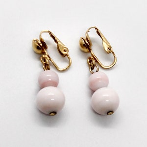 Vintage light pink double ball dangling clip-on earrings with gold tone hardware ; about 1 1/4 in. long