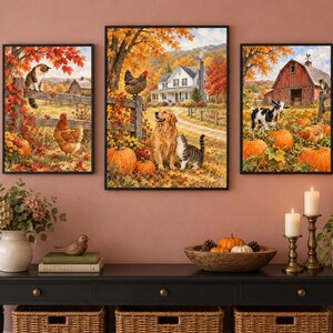 May include: A set of three framed wall art prints depicting autumn farm scenes. The images feature a golden retriever, cats, chickens, a goat, pumpkins, and a red barn surrounded by vibrant orange and yellow fall foliage in a rural landscape.