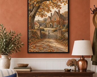 May include: A framed wall art print depicting a stone manor house behind a black metal gate, surrounded by large trees with orange and yellow autumn foliage. A gravel path covered in fallen leaves leads to the entrance of the building.