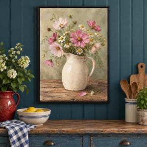 May include: A framed painting of a bouquet of pink cosmos and white daisies in a cream-colored ceramic pitcher. The pitcher sits on a wooden surface against a muted green background. The flowers feature shades of pink, white, and yellow centers.