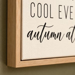 May include: A framed canvas wall art piece featuring black text on a cream-colored background. The visible text reads COOL EVE and autumn at. The canvas is encased in a light-toned wooden frame with a clean, simple edge profile.