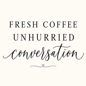May include: A white wall art print featuring black text that reads FRESH COFFEE UNHURRIED conversation. The first two lines are in a clean serif font, while the word conversation is in a flowing script font with a small heart icon below.