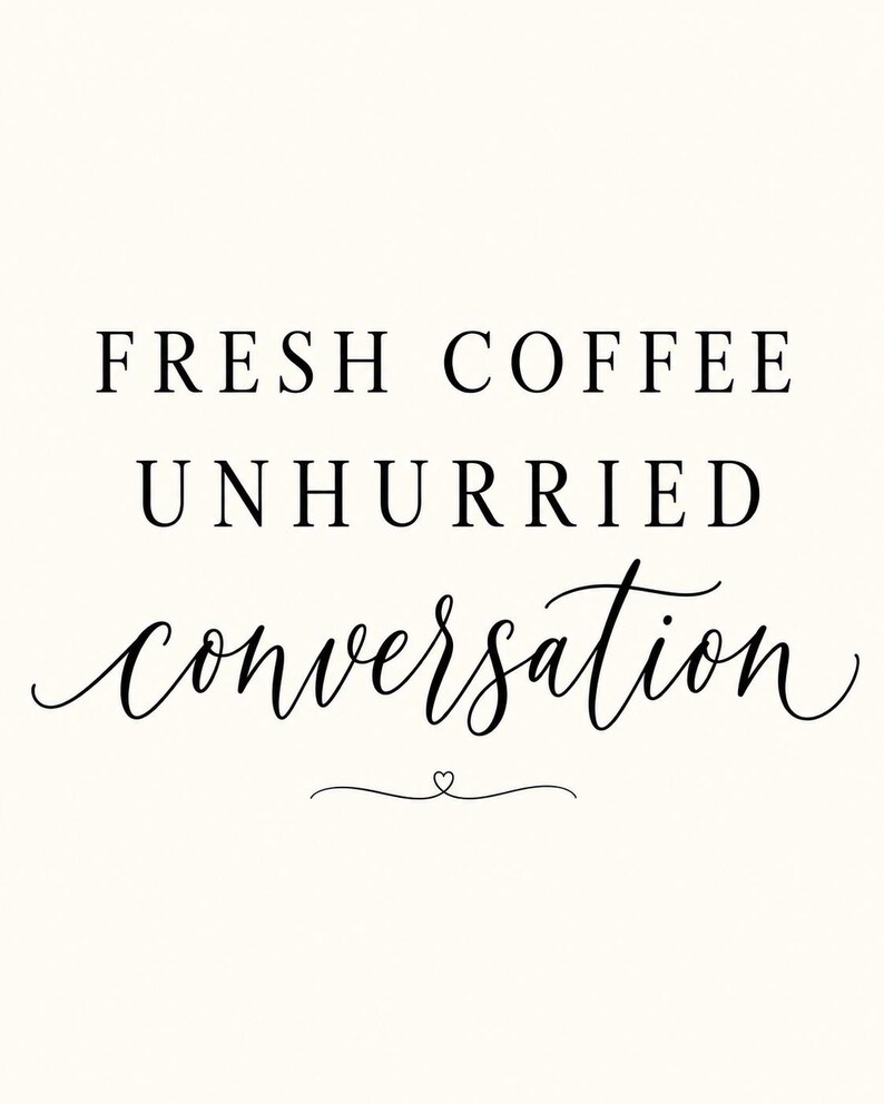 May include: A white wall art print featuring black text that reads FRESH COFFEE UNHURRIED conversation. The first two lines are in a clean serif font, while the word conversation is in a flowing script font with a small heart icon below.