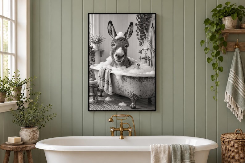 May include: A black and white framed wall art print depicting a donkey sitting in a clawfoot bathtub filled with soap bubbles. The donkey has foam on its head and ears, and a striped towel hangs over the side of the tub in the scene.