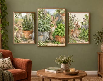 May include: A set of three framed wall art prints featuring brown rabbits in a garden setting. The artwork displays rabbits surrounded by potted herbs, including rosemary, sage, and basil, with a small bird perched on a metal watering can.