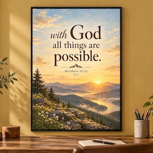 May include: A framed wall art print featuring a sunrise over a mountain range and lake, with the text "with God all things are possible. Matthew 19:26 KJV" printed in dark brown lettering against a sky with clouds and pine trees.