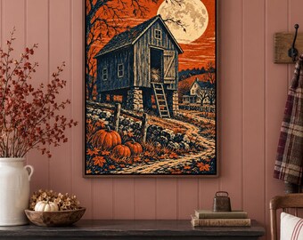 May include: A framed wall art print depicting a rustic wooden barn elevated on stone pillars, set against a vibrant orange sky with a large full moon. In the foreground, orange pumpkins rest on a path near a stone wall and bare trees.