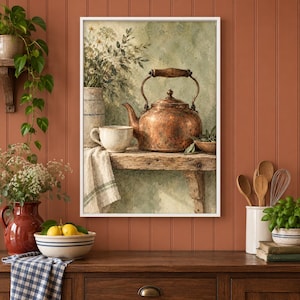 May include: A framed wall art print depicting a copper kettle, a ceramic cup, and a vase of wildflowers on a rustic wooden shelf. The scene features a textured, muted green background, a white cloth with green stripes, and a weathered wooden surface.