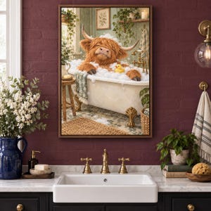 May include: A framed wall art print depicting a brown Highland cow with long horns relaxing in a white clawfoot bathtub filled with soap bubbles. A small yellow rubber duck floats in the bubbles. The scene is set in a bathroom with green walls.