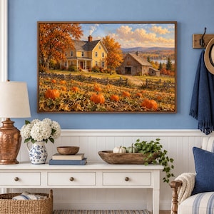 May include: A rectangular framed wall art print depicting a rural autumn landscape with a yellow farmhouse, a wooden barn, and a field filled with orange pumpkins under a soft sunset sky with scattered clouds and golden trees.