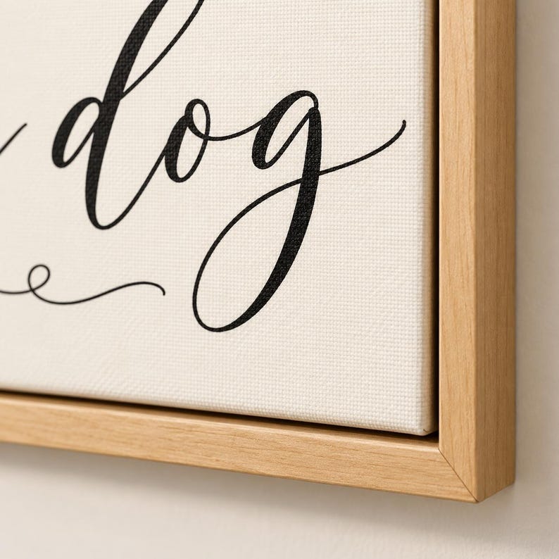 May include: A rectangular canvas wall art piece featuring black cursive text that includes the word dog, set against a cream-colored background. The canvas is encased in a light-toned wooden frame with a clean, simple edge profile.