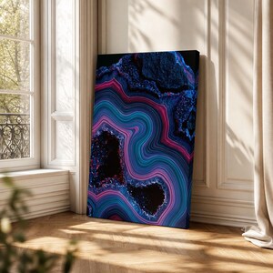 May include: A rectangular canvas print featuring a vibrant abstract pattern of swirling agate-like bands in shades of deep blue, magenta, and cyan, with dark, textured crystalline voids interspersed throughout the composition.