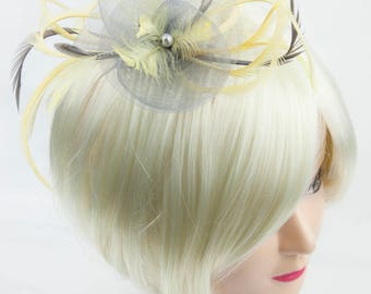 Silver grey fascinator with accent colour of lemon yellow. On a clip, comb or Alice band