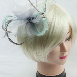 Silver grey fascinator with accent colour of pale pastel green. On a clip, comb or Alice band