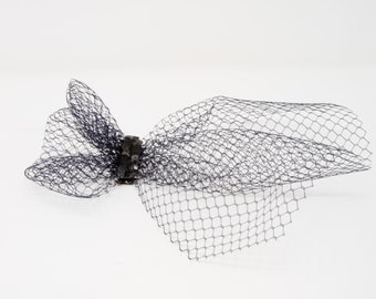 Black french veil fascinator on a clip.