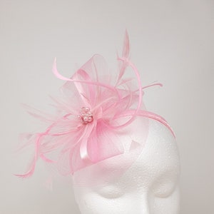 Pink fascinator attached to clip, comb and Alice band