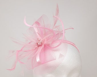 Pink fascinator attached to clip, comb and Alice band