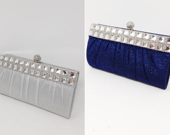 Silver or cobalt blue pleated clutch bag with rhinestone detail.