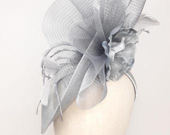 Silver shimmering round hatinator style fascinator on alice band.