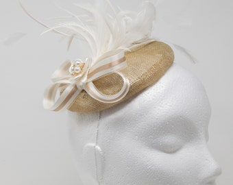 Champagne shimmering gold and ivory hatinator fascinator with pearl and rhinestone brooch.