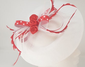 White hatinator with red and white polka dot ribbon on comb, clip and alice band.