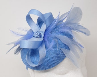 Cornflower blue percher style button fasinator with feathers.