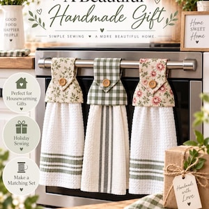 May include: Three hanging kitchen towels with buttoned fabric tops, featuring green leaf, green gingham, and pink floral patterns. The towels are white with green stripes and a waffle texture, hanging from a stainless steel oven handle.
